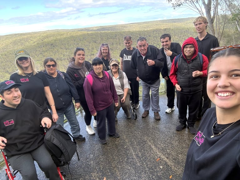 Group of teenagers taking a selfie on a rural road with hills in the background